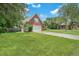 Brick home with a spacious yard and attached garage at 8300 Berringer Bluff Dr, Charleston, SC 29418