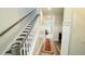 Elegant staircase with dark wood steps and white railings, leading to the upper level at 102 Split Leaf Ln, Summerville, SC 29483