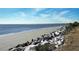 Stunning beach shoreline with rock jetty and calm ocean at 1647 Live Oak Park, Seabrook Island, SC 29455