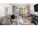 Bright living room with comfy seating, a glass coffee table, and access to a screened porch at 1647 Live Oak Park, Seabrook Island, SC 29455