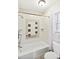 Main floor bathroom with shower/tub, grab bars, and tile surround at 257 Savannah Round, Summerville, SC 29485