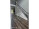 Modern staircase with metal railing and dark gray treads at 4504 Smoak Rd, Meggett, SC 29449