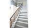 Modern staircase with gray treads and black metal railing at 4504 Smoak Rd, Meggett, SC 29449