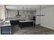 Modern kitchen with white and dark blue cabinets, quartz countertops and a large island at 4504 Smoak Rd, Meggett, SC 29449