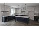 Modern kitchen with white and dark blue cabinets, quartz countertops, and a large island at 4504 Smoak Rd, Meggett, SC 29449