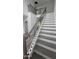 Two-story staircase with a metal railing and gray steps at 4504 Smoak Rd, Meggett, SC 29449