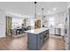 Open concept kitchen with island, dining area, and hardwood floors at 450 Ripple Park Dr, Summerville, SC 29486
