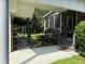Home exterior showcasing a screened porch and fenced yard at 86 Watershed Ct, Walterboro, SC 29488