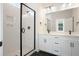 Modern bathroom featuring a walk-in shower, double vanity, and dark tile flooring at 414 Queenview Ln, Charleston, SC 29414