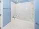 Bathroom with white tile, bathtub, and built-in shelving at 687 Oak Marsh Dr, Mount Pleasant, SC 29464