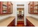 Spacious butler's pantry with granite countertops and glass-front cabinets, leading to dining room at 687 Oak Marsh Dr, Mount Pleasant, SC 29464