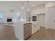 Modern kitchen with white cabinets, island, stainless steel appliances, and view of the living room at 509 Twin Lakes Dr, Summerville, SC 29483