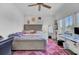 Bright bedroom with a queen bed, workspace, and ceiling fan at 315 Ashley Ave # C, Charleston, SC 29403