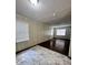 Living area with wood-look floors and large windows at 313 Pine Needle Rd, Walterboro, SC 29488