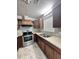 L-shaped kitchen with stainless steel appliances and wood cabinets at 313 Pine Needle Rd, Walterboro, SC 29488