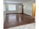 Living room with wood-look floors and a door to entryway at 313 Pine Needle Rd, Walterboro, SC 29488
