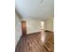 Living area with wood-look floors and access to kitchen at 313 Pine Needle Rd, Walterboro, SC 29488