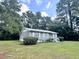 Ranch style home with gray siding, metal roof and landscaped yard at 313 Pine Needle Rd, Walterboro, SC 29488