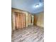 Bright bedroom with wood-look floors and access to hallway at 313 Pine Needle Rd, Walterboro, SC 29488
