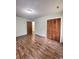Spacious bedroom with wood-look floors and a door to another room at 313 Pine Needle Rd, Walterboro, SC 29488