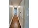 Hardwood floors and neutral walls in this long hallway at 201 Josie Dr, Walterboro, SC 29488