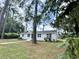 White brick ranch house nestled among tall trees at 201 Josie Dr, Walterboro, SC 29488