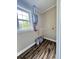 Laundry room with water heater, window and vinyl flooring at 201 Josie Dr, Walterboro, SC 29488