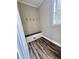 Laundry room with built-in bench, window, and vinyl flooring at 201 Josie Dr, Walterboro, SC 29488