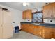 Functional laundry room with wood cabinets and a built-in sink at 2773 Mt Carmel Rd, Walterboro, SC 29488