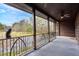 Covered porch with wooden beams, iron railing, and scenic wooded views at 2773 Mt Carmel Rd, Walterboro, SC 29488
