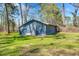 A gray storage shed nestled amongst lush green trees at 2773 Mt Carmel Rd, Walterboro, SC 29488