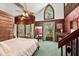 Main bedroom with a cozy sitting area, fireplace, and wood-paneled walls at 2773 Mt Carmel Rd, Walterboro, SC 29488