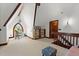 Spacious loft sitting area with built-in shelving and arched window at 2773 Mt Carmel Rd, Walterboro, SC 29488