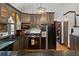 Modern kitchen with black appliances and dark wood cabinets at 2773 Mt Carmel Rd, Walterboro, SC 29488