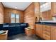 Bathroom with wooden walls, dark vanity, and soaking tub at 2773 Mt Carmel Rd, Walterboro, SC 29488