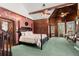 Spacious bedroom with a large bed, green carpet, and unique wallpaper at 2773 Mt Carmel Rd, Walterboro, SC 29488