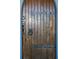 Detailed wooden door with iron hinges and ring at 2773 Mt Carmel Rd, Walterboro, SC 29488