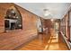 Sunroom features wood walls, hardwood floors, and large windows overlooking the garden at 2773 Mt Carmel Rd, Walterboro, SC 29488
