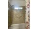 Bathroom with tub and shower, grab bar and updated tile at 422 Constance St, Walterboro, SC 29488