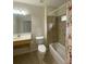 Clean bathroom with tub shower, grab bars, and updated vanity at 422 Constance St, Walterboro, SC 29488