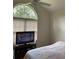 Bedroom with large window, TV, and ceiling fan at 422 Constance St, Walterboro, SC 29488