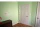 Light-green bedroom with wood floors and a closet at 422 Constance St, Walterboro, SC 29488