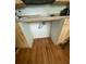 View under kitchen counter, showing electrical outlet and hardwood floors at 422 Constance St, Walterboro, SC 29488