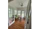 Sunroom with hardwood floors, ceiling fan, and French doors at 422 Constance St, Walterboro, SC 29488