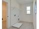Bright laundry room with tile floor, shelving, and closet access at 2193 Blue Bayou Blvd, Johns Island, SC 29455