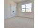 Bright bedroom with carpeted floor and double doors at 2193 Blue Bayou Blvd, Johns Island, SC 29455