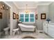 Bathroom with soaking tub, marble floors, and large windows at 6949 Maybank Hwy, Wadmalaw Island, SC 29487