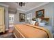 Main bedroom with king bed, decorative pillows, and access to the bathroom at 6949 Maybank Hwy, Wadmalaw Island, SC 29487