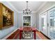 Elegant dining room with hardwood floors, chandelier, and French doors at 6949 Maybank Hwy, Wadmalaw Island, SC 29487