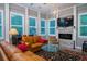 Relaxing sunroom featuring a fireplace, leather seating, and a large TV at 6949 Maybank Hwy, Wadmalaw Island, SC 29487